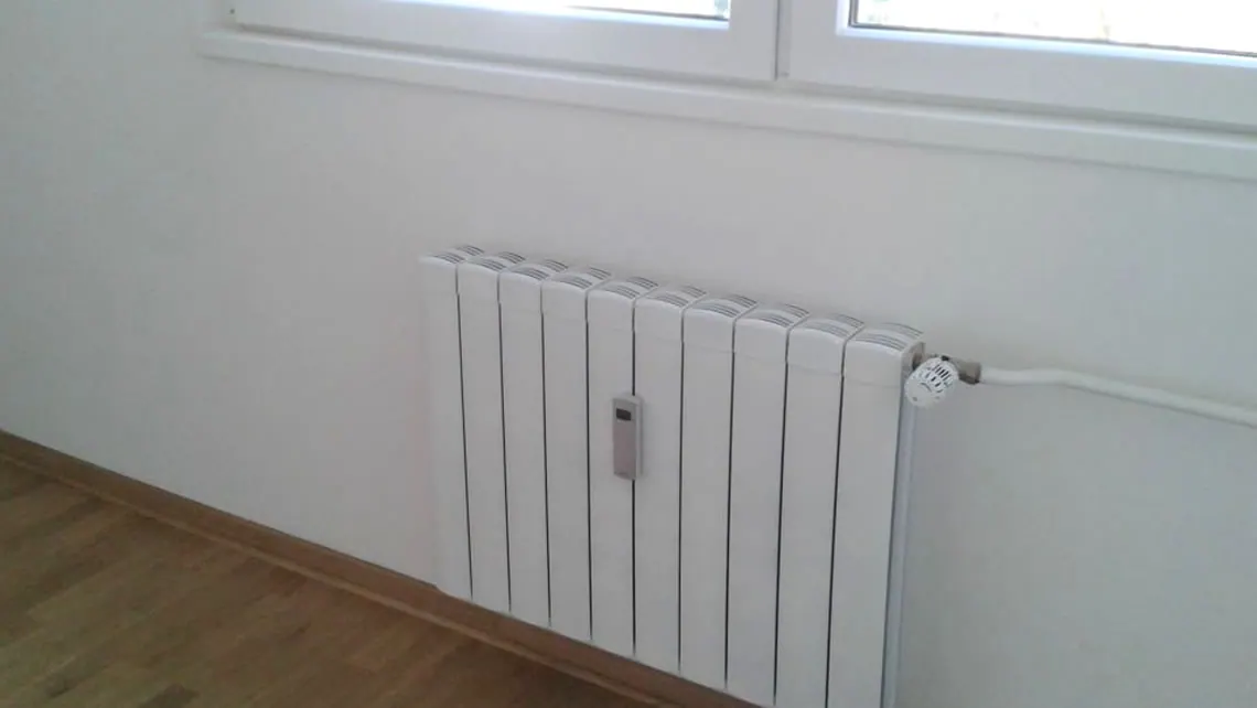 Radiator installed beneath a window